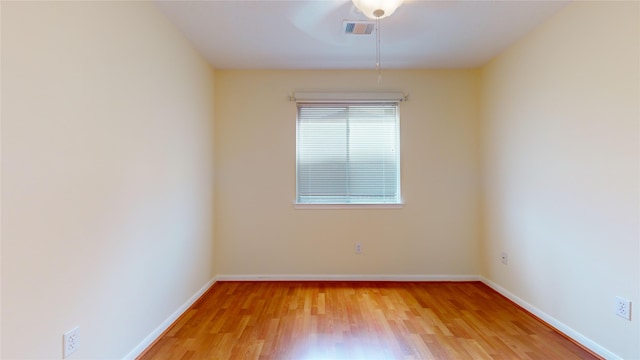 empty room with hardwood / wood-style floors