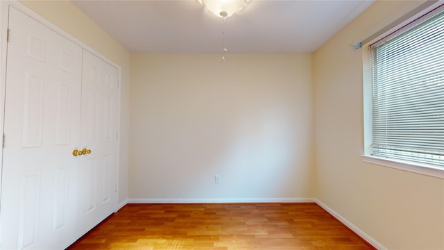 empty room with a wealth of natural light and light wood-type flooring