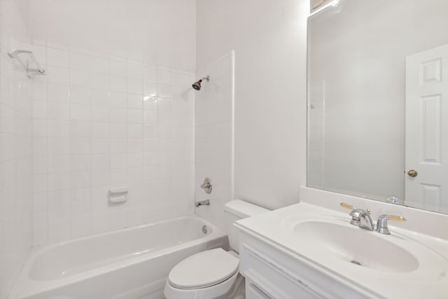 full bathroom featuring vanity, tiled shower / bath combo, and toilet