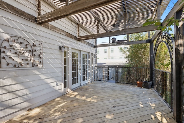 wooden terrace featuring a pergola, ceiling fan, and french doors