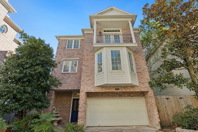 view of front of property featuring a garage and a balcony