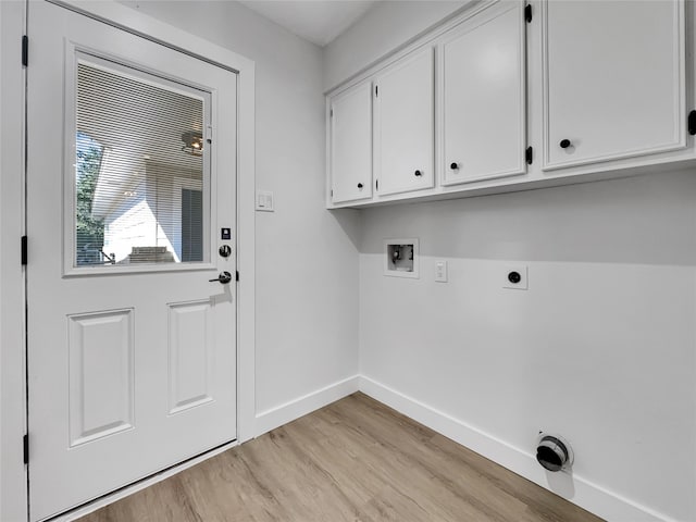 clothes washing area with electric dryer hookup, cabinets, light wood-type flooring, and hookup for a washing machine