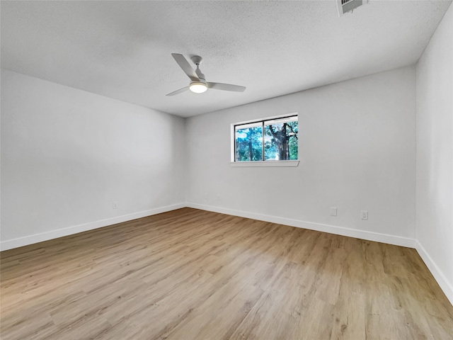 empty room featuring a textured ceiling, light hardwood / wood-style flooring, and ceiling fan