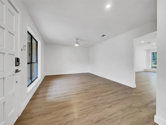 spare room featuring light hardwood / wood-style flooring and ceiling fan