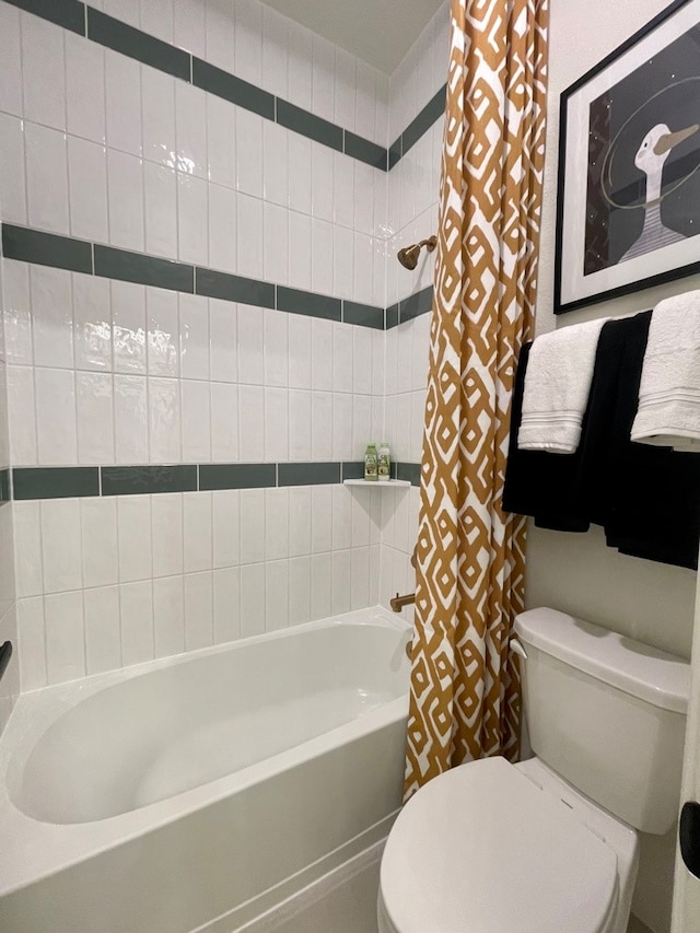 bathroom with shower / bath combo with shower curtain and toilet