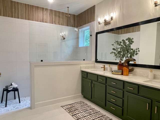 bathroom with vanity, tiled shower, and tile patterned floors