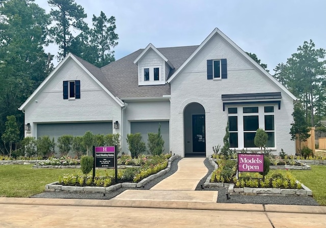 view of front of property with a front yard and a garage