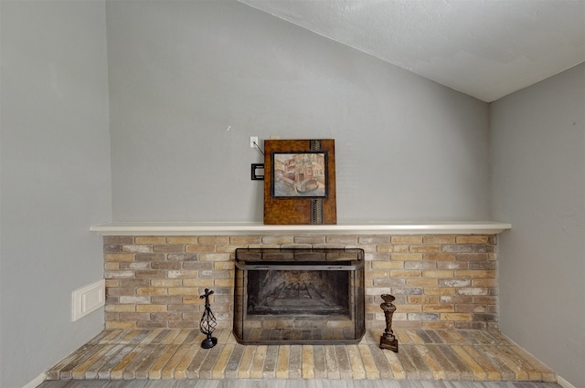 interior details featuring a fireplace and hardwood / wood-style flooring