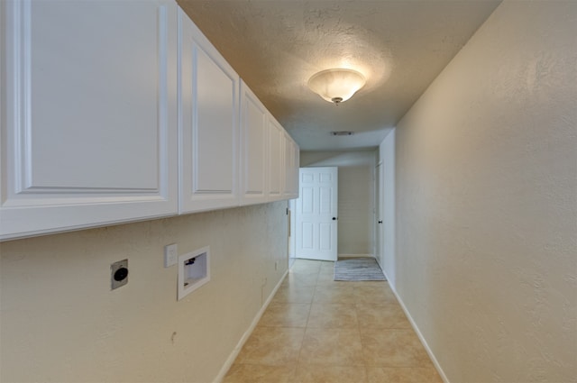 clothes washing area featuring cabinets, electric dryer hookup, hookup for a washing machine, a textured ceiling, and light tile patterned flooring