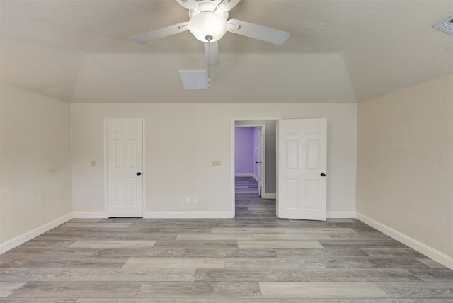 unfurnished room with vaulted ceiling, ceiling fan, and light hardwood / wood-style floors