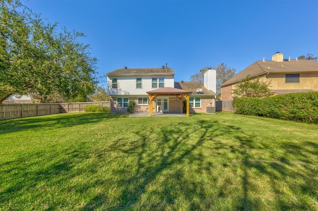 rear view of property with a yard and a patio area