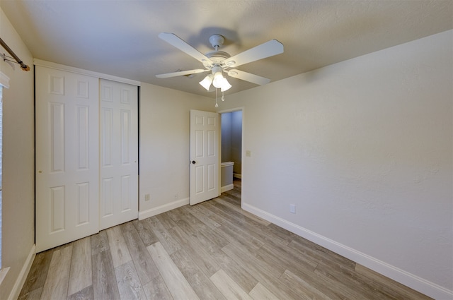 unfurnished bedroom featuring a closet, ceiling fan, and light wood-type flooring