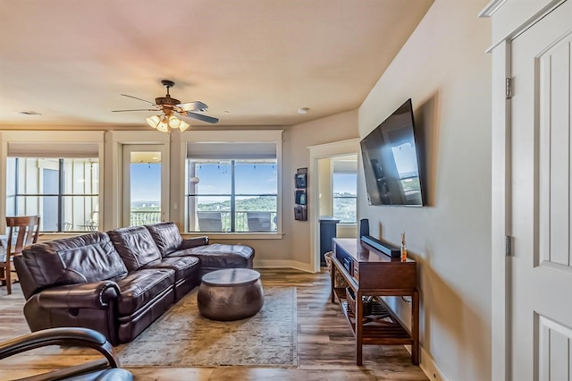 living room with wood-type flooring and ceiling fan