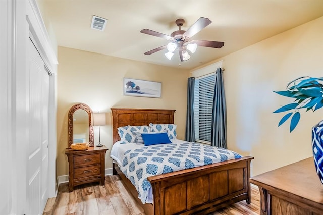 bedroom featuring a closet, light hardwood / wood-style flooring, and ceiling fan