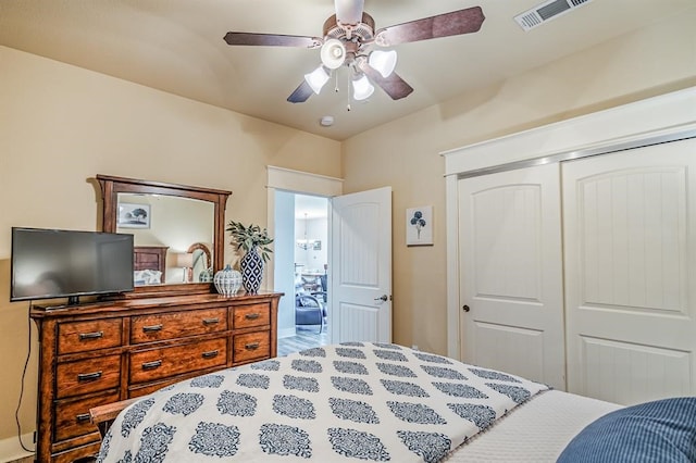 bedroom with a closet, hardwood / wood-style floors, and ceiling fan