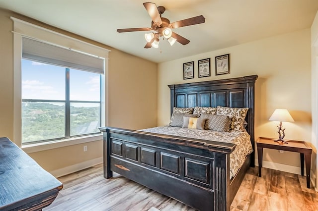 bedroom with ceiling fan and light wood-type flooring