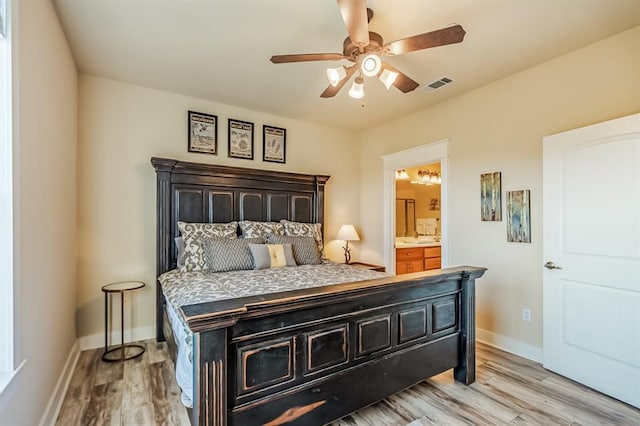 bedroom featuring ensuite bath, ceiling fan, and light wood-type flooring