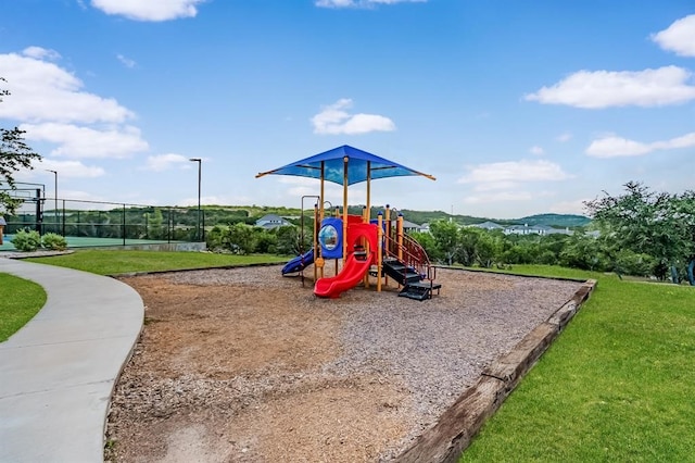 view of play area featuring a mountain view and a lawn