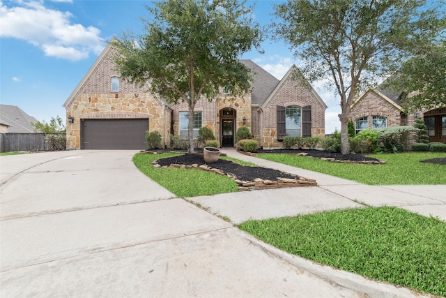 view of front of house featuring a garage and a front lawn