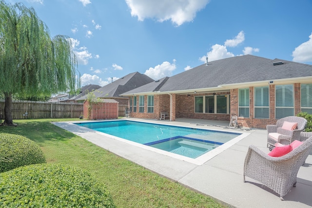 view of swimming pool featuring an in ground hot tub, a patio, and a yard