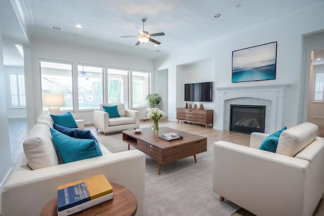 living room featuring ornamental molding and ceiling fan