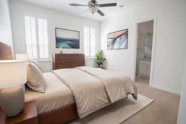 bedroom featuring ensuite bath, ceiling fan, and carpet floors