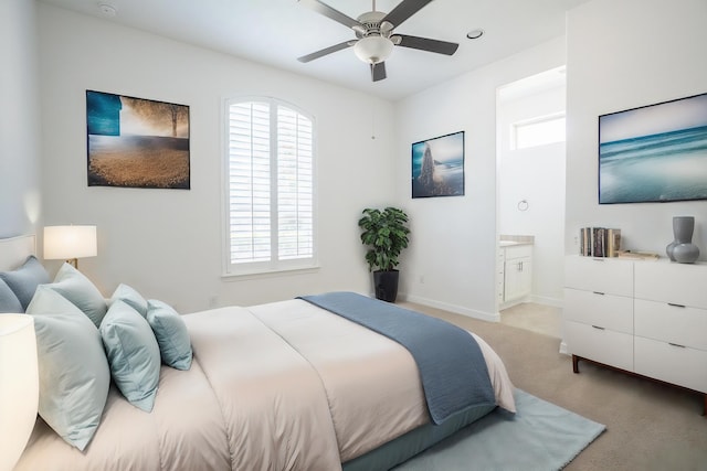 bedroom with connected bathroom, ceiling fan, and light colored carpet