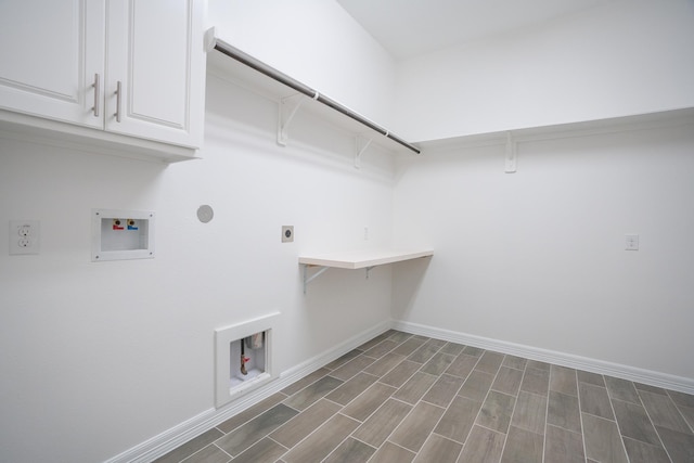 laundry room with cabinets, hookup for a washing machine, dark hardwood / wood-style flooring, gas dryer hookup, and electric dryer hookup