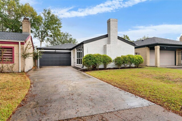 11207 Wood Lodge Dr, Houston, TX 77077 - view of side of property with a lawn, a garage, asphalt driveway, a chimney, and brick siding