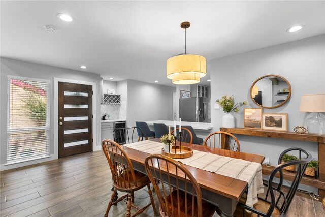 11207 Wood Lodge Dr, Houston, TX 77077 - dining area with wood finished floors, beverage cooler, and recessed lighting