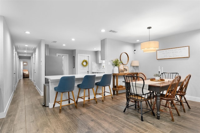 11207 Wood Lodge Dr, Houston, TX 77077 - dining room with attic access, wood finished floors, baseboards, and recessed lighting