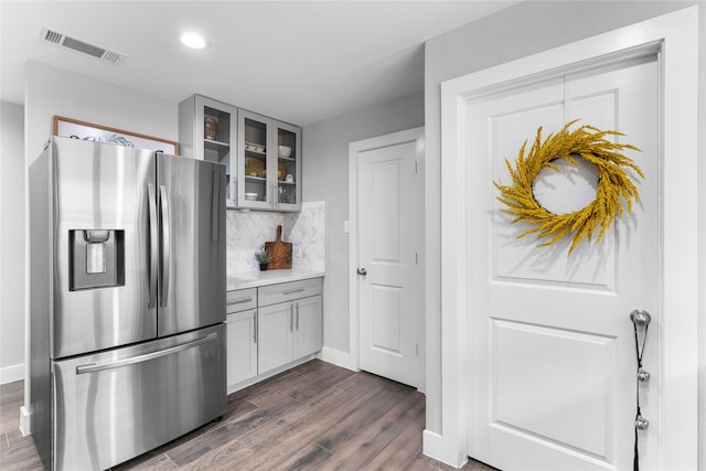 11207 Wood Lodge Dr, Houston, TX 77077 - kitchen featuring stainless steel fridge, glass insert cabinets, tasteful backsplash, dark wood finished floors, and gray cabinetry