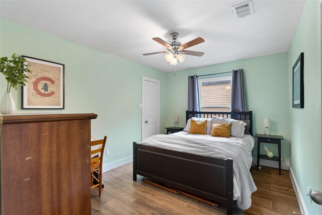 11207 Wood Lodge Dr, Houston, TX 77077 - bedroom with wood finished floors, baseboards, and ceiling fan
