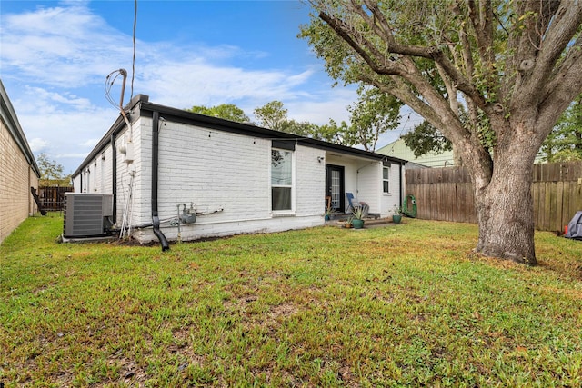 11207 Wood Lodge Dr, Houston, TX 77077 - rear view of house featuring cooling unit and brick siding