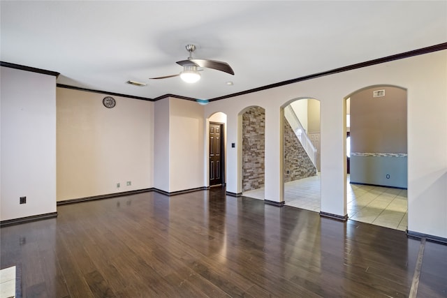 empty room with ceiling fan, hardwood / wood-style floors, and crown molding