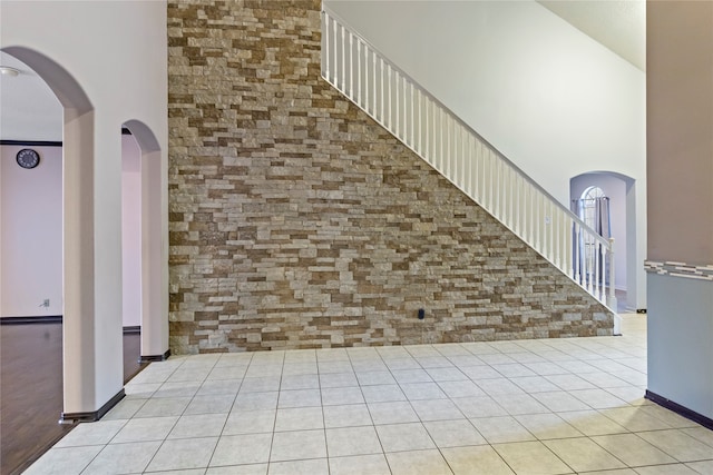 interior space featuring a high ceiling and light tile patterned floors