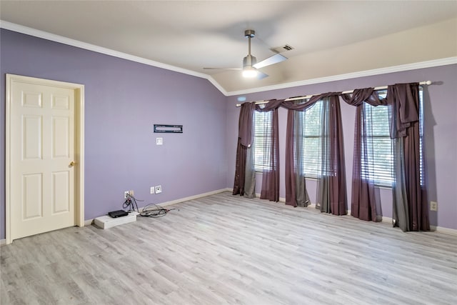 empty room with ceiling fan, crown molding, light hardwood / wood-style floors, and lofted ceiling