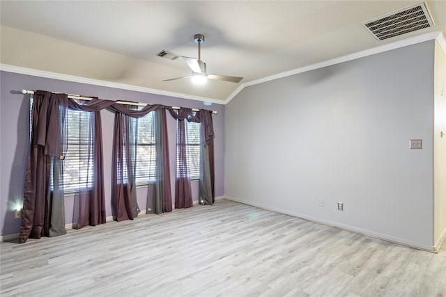 spare room featuring lofted ceiling, light hardwood / wood-style floors, ceiling fan, and crown molding