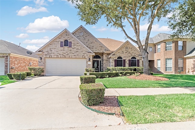 view of front of home with a front lawn and a garage