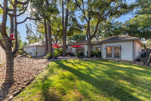 back of property with a lawn