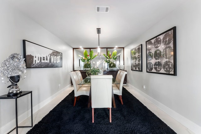 dining space featuring light tile patterned floors