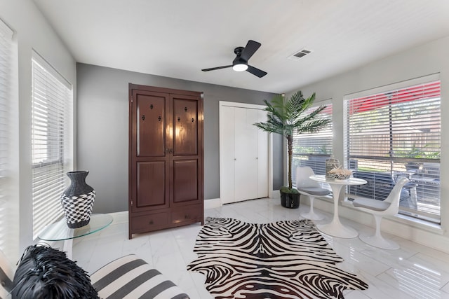 living area featuring ceiling fan