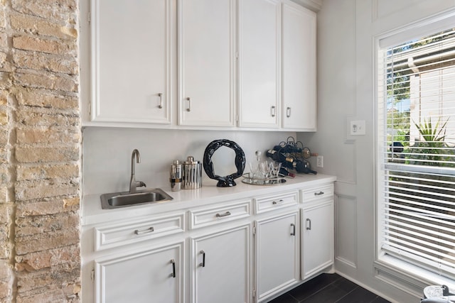 bar featuring sink and white cabinets