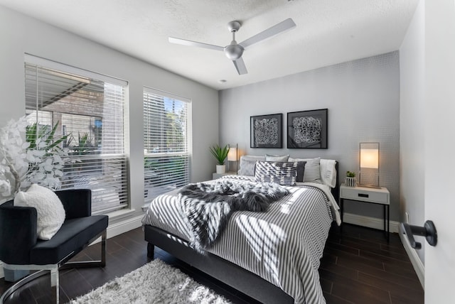 bedroom featuring a textured ceiling, ceiling fan, and dark hardwood / wood-style floors