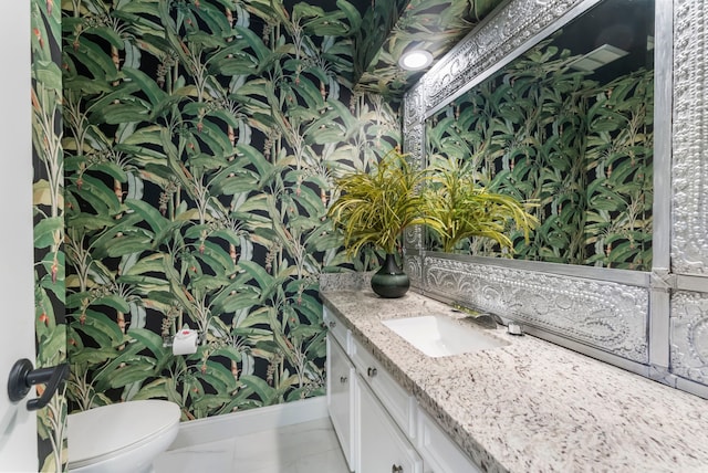 bathroom featuring tile patterned flooring, vanity, and toilet