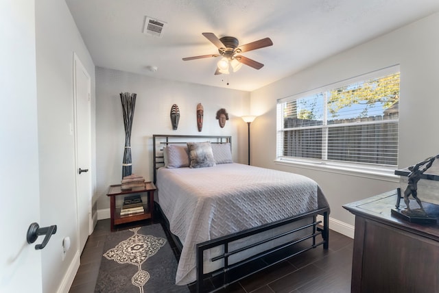 bedroom featuring ceiling fan and dark hardwood / wood-style flooring