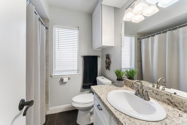 bathroom with curtained shower, toilet, vanity, and hardwood / wood-style flooring