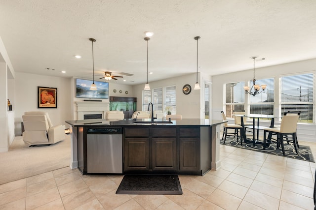 kitchen featuring dark brown cabinets, dishwasher, sink, and plenty of natural light