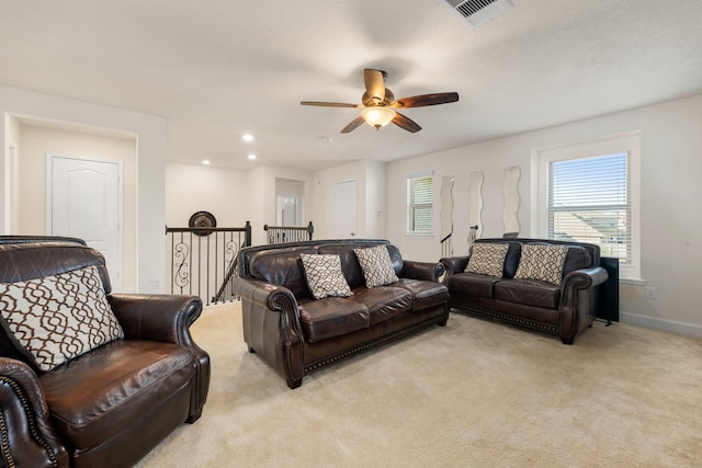 carpeted living room with ceiling fan