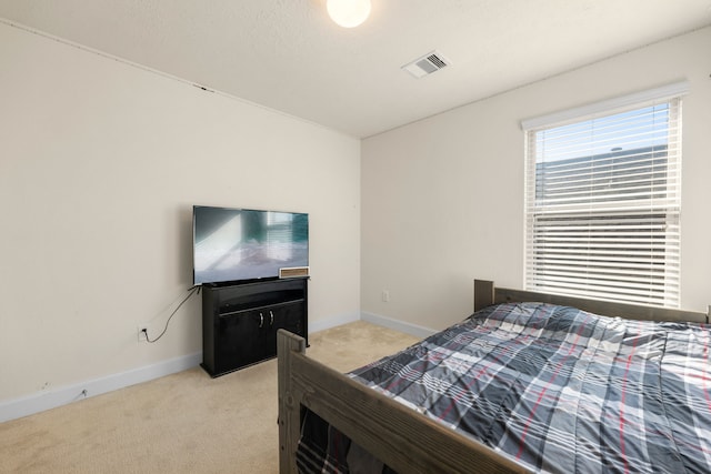 bedroom with light colored carpet